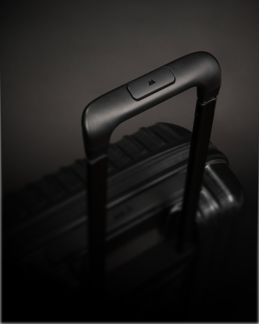 Black suitcase handle on a dark background