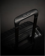 Black suitcase handle on a dark background